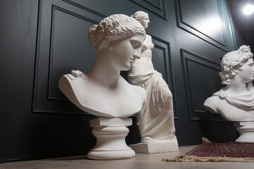 Gypsum copy of ancient statue Apollo, Aphrodite and Venus statue on dark textured background. Plaster sculpture face.