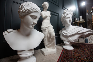 Gypsum copy of ancient statue Apollo, Aphrodite and Venus statue on dark textured background....