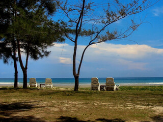 Tropical Beach Scene in Sabah Malaysian Borneo with Sun Loungers