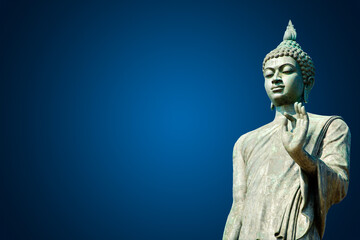 Old standing buddha on blue background.