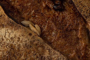 Round bread close-up. Freshly baked sourdough bread with a golden crust. Baker shop context with delicious bread. Pastry items.