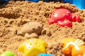 Fototapeta na wymiar Plastic molds used by children to create different animals and shapes in the sand box
