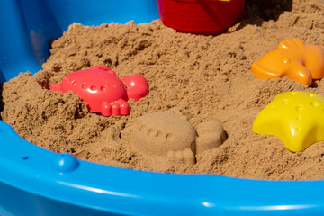 Fototapeta na wymiar Plastic molds used by children to create different animals and shapes in the sand box