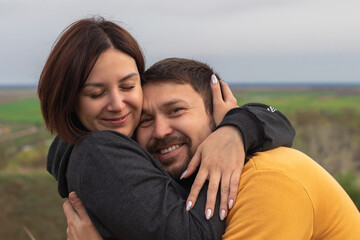 young couple passionately hugging outside