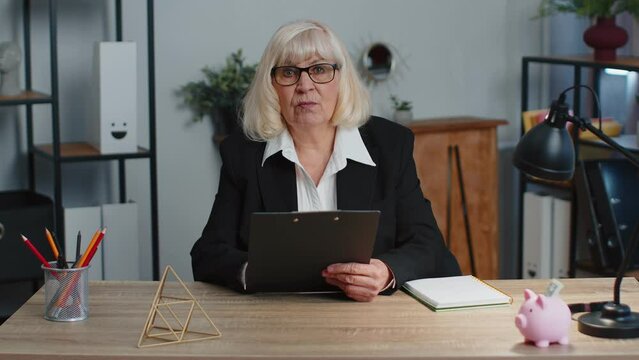 Refusal rejection fail to hire. Senior old business woman ceo director sitting at workplace desk, looking at camera and having interview job discussion, video conference call. Working at home office