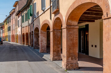 Fototapeta na wymiar The colorful arcades of via Sanvitale, historic center of Fontanellato, Parma, Italy