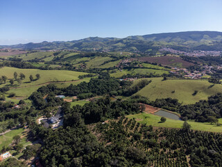 Fototapeta na wymiar fields with plantations in small mountains in a city in the interior - Socorro, São Paulo, Brazil