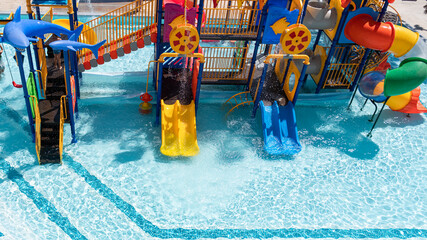 Children Playground with Colorful Yellow And Blue Plastic Slider in Swimming Pool Aquapark