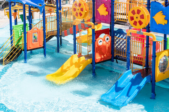 Children Playground with Colorful Yellow And Blue Plastic Slider in Swimming Pool Aquapark