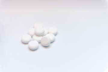 white pills on white background