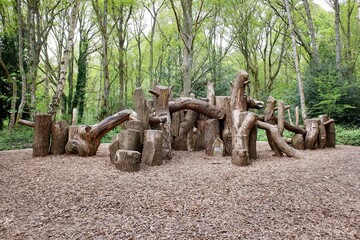 Natural woodland play area made with sustainably felled oak tree trunks on Chorleywood Common, Hertfordshire, England, UK