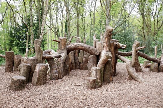 Natural woodland play area made with sustainably felled oak tree trunks on Chorleywood Common, Hertfordshire, England, UK