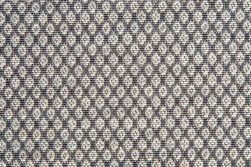 Knitted texture. Texture of jacquard fabric with gray geometric pattern. Crochet mosaic pattern