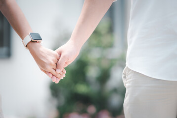 The groom holds the bride's hand