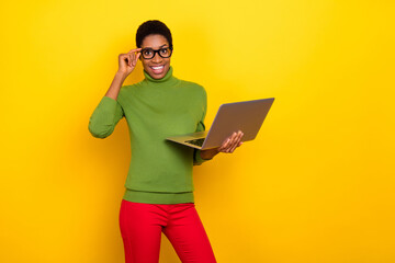 Photo of charming clever trans woman wear green turtleneck writing modern device empty space isolated yellow color background