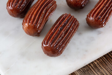 Chocolate Tulumba dessert served on the marble 