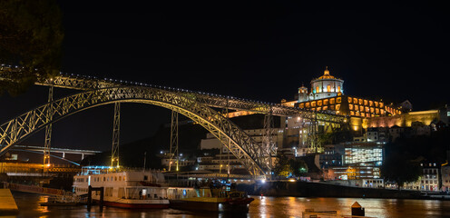 Fototapeta na wymiar Porto, Portugal - november 8 2022 - Luis I Bridge crossing the Duoro river at night
