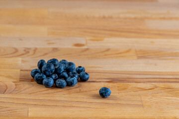 closeup of a bunch of blueberries on a wooden background