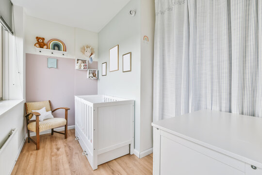 Interior of bedroom with baby crib in daytime