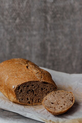 Composition of freshly baked bread on old wooden background