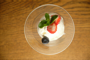 Ice cream in a glass martinique with mint leaf and strawberries