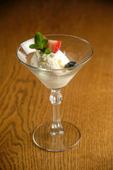 Ice cream in a glass martinique with mint leaf and strawberries