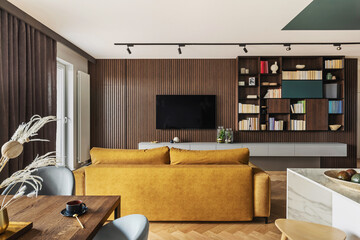 Creative and modern vintage living room interior design with yellow sofa and lamella wall with tv...