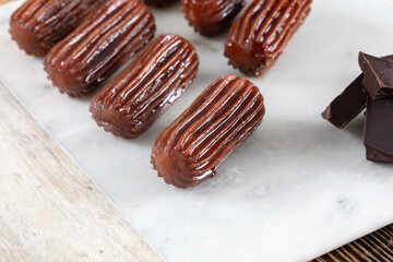 Chocolate Tulumba dessert served on the marble 