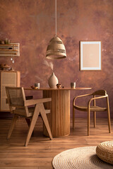 Stylish boho vintage dining room interior with poster mock up. Round table with rattan chair, vase with dried flowers. Brown wall and rattan lamp. Mock up poster. Template.