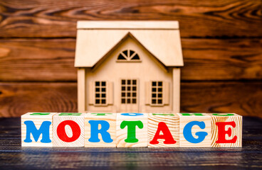 Wooden home and text on the cubes MORTAGE

