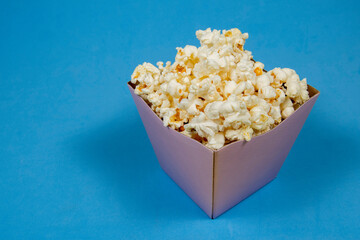 A paper bowl of salted popcorn