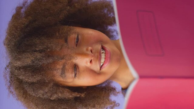 Vertical Video Of Young Boy Studying School Exercise Book Against Purple Background