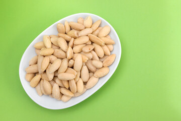 clean almonds on small white dish on green