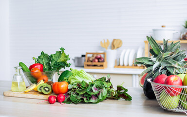 Background of green vegetables, fruits, lemon, kiwi, cherries and red tomatoes for good health...