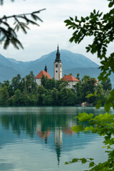 Obraz premium Most famous Slovenian lake and island Bled. Lake Bled. Lake Bled Slovenia. Beautiful mountain lake with small Pilgrimage Church. 