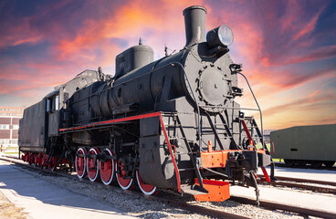 Fototapeta premium Vintage steam locomotive against the sky