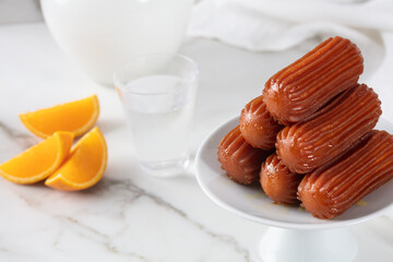 Tulumba dessert served with orange