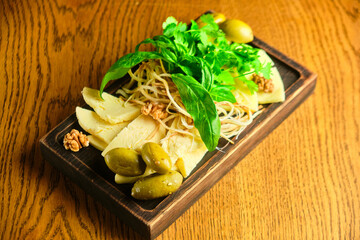 rye bruschetta with honey pumpkin and goat cheese on a dark wood background. tinting. selective focus on mint on the front bruschetta