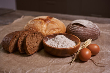fresh bread and baked goods on wooden chopping board, rustic style