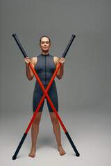 beautiful girl in sports uniform is training kung fu in the studio, fighter athlete, practicing...