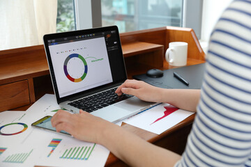 A woman using computer prepare financial graph diagram