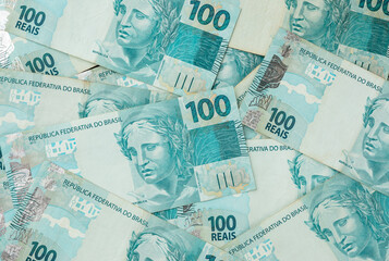 A groud of hundred brazilian real bills spread