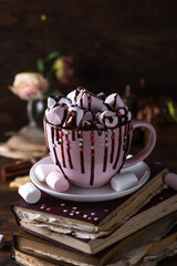 A mug of hot cocoa, full of marshmallows and sprinkled with chocolate on top