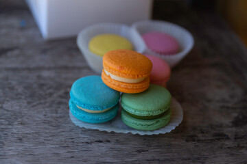 colorful macarons on wooden table.