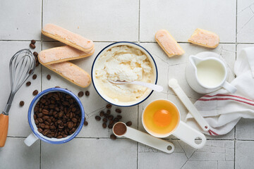 Tiramisu dessert. Ingredients for making dessert tiramisu. Cooking Italian food dessert Tiramisu with all necessary ingredients cocoa, coffee, mascarpone cheese on grey stone background. Copy space