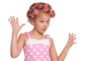 Portrait of emotional little pretty girl with hair curlers on white background