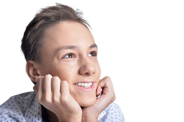 Studio portrait of smiling teenage boy on white background