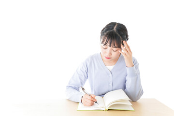 Young student thinking at desk