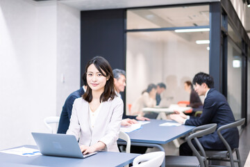 A career woman working at her desk in a shared office