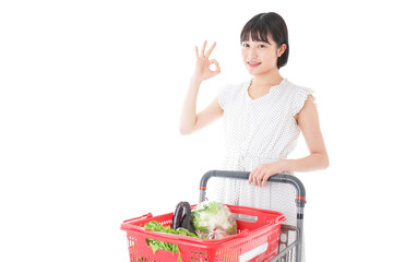Young woman giving OK sign at supermarket